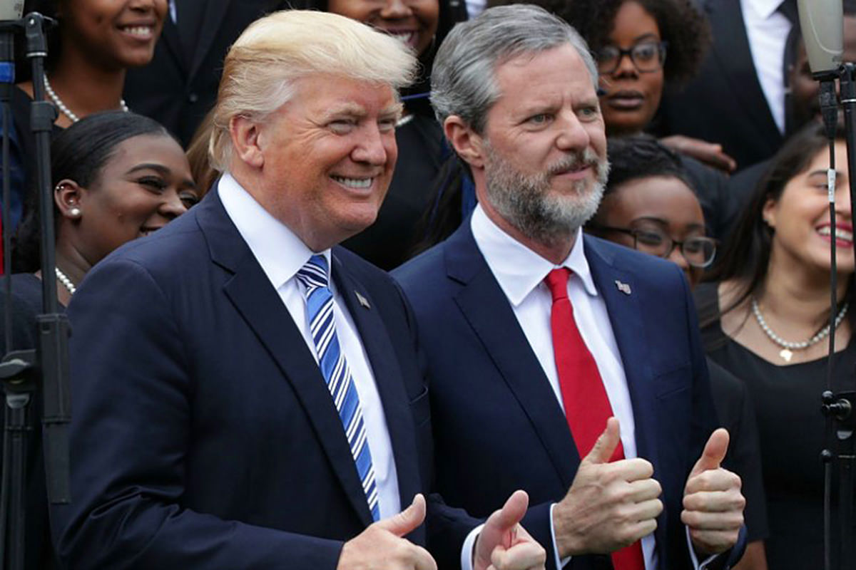 President Trump and Jerry Falwell Jr. giving the double-thumbs-up and looking like the assholes they are.