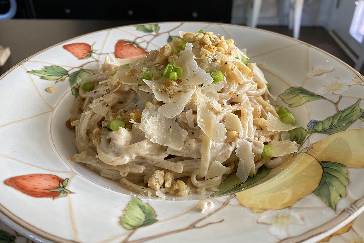 A beautiful plate of walnut cream sauce on pasta.