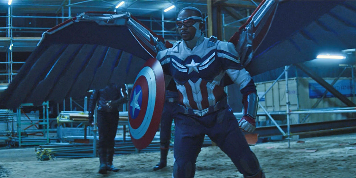 Captain America with his shield and wings facing off with Flag Smashers at a construction site.