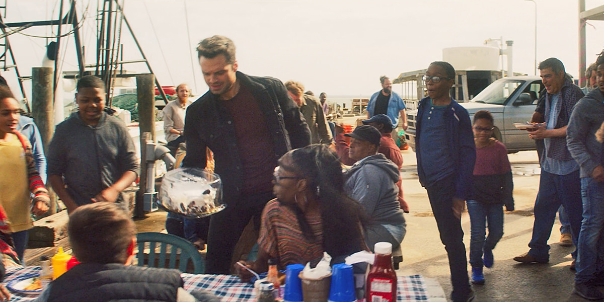 Bucky bringing a dessert to a family picnic at Sam's family's place in Louisiana.