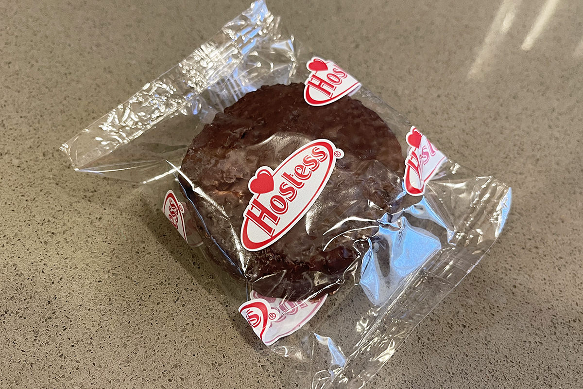 A Hostess Ding Dong snack WRAPPED IN PLASTIC.