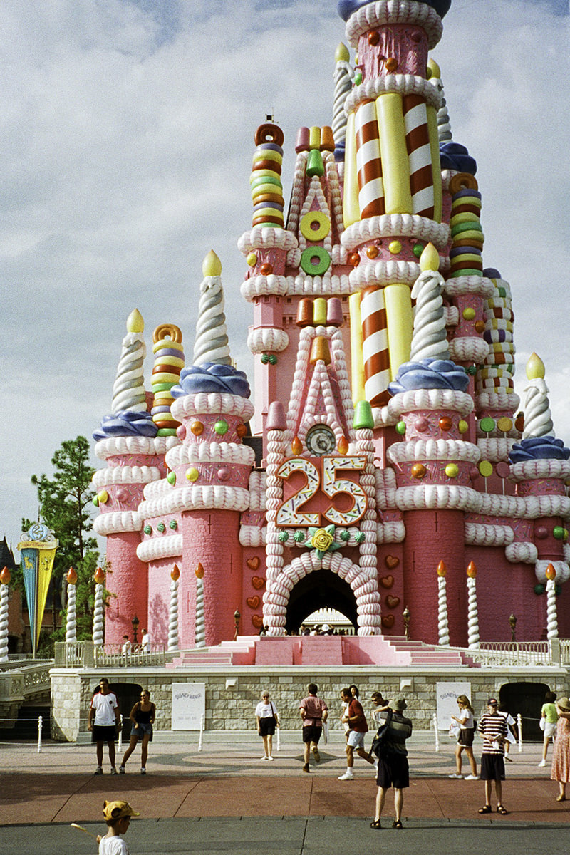 The hideous Cinderella Castle Birthday Cake all gaudy in pink and yellow.