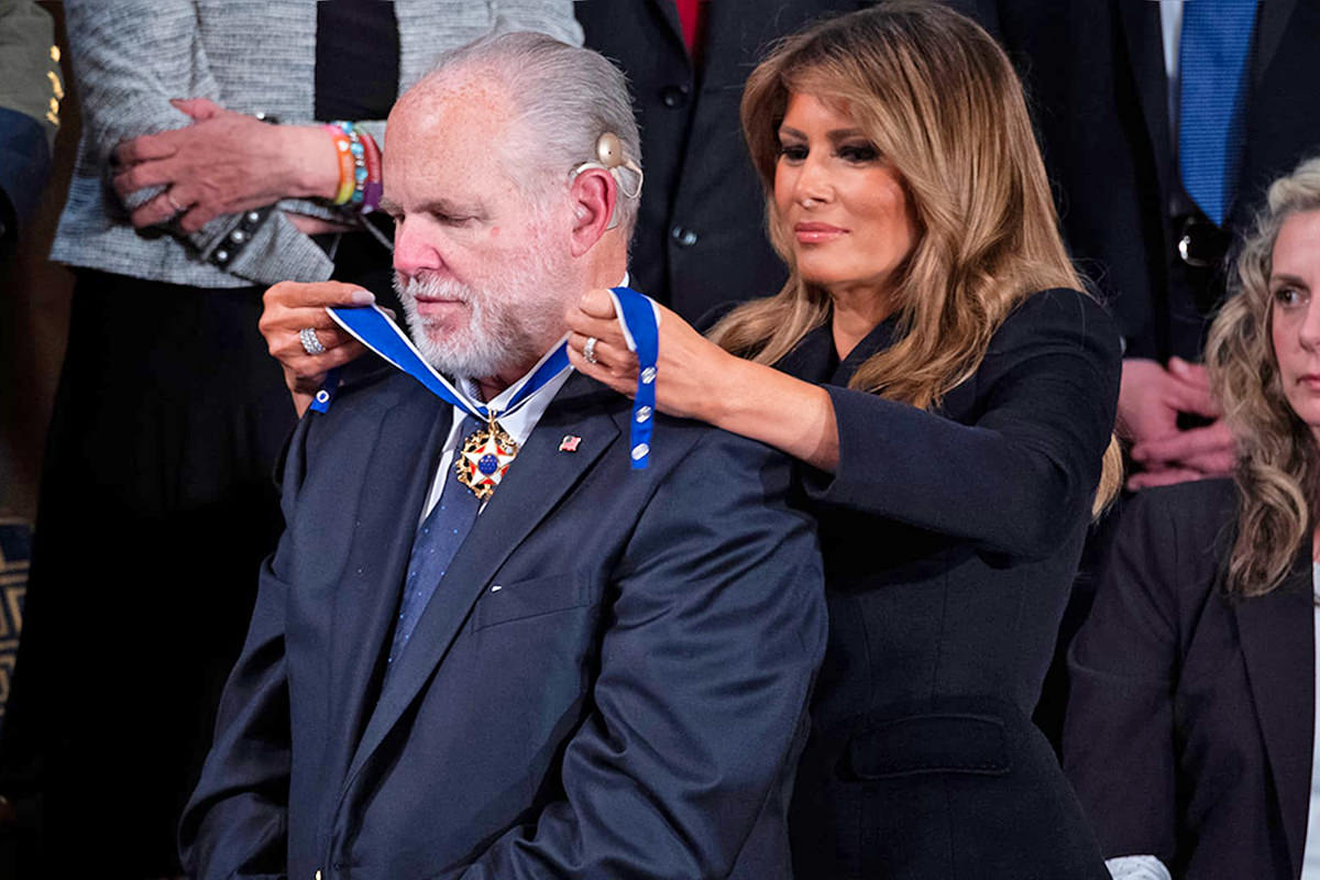 Former First Lady Melania Trump puts the Presidential Medal of Freedom around Rush Limbaugh's neck.