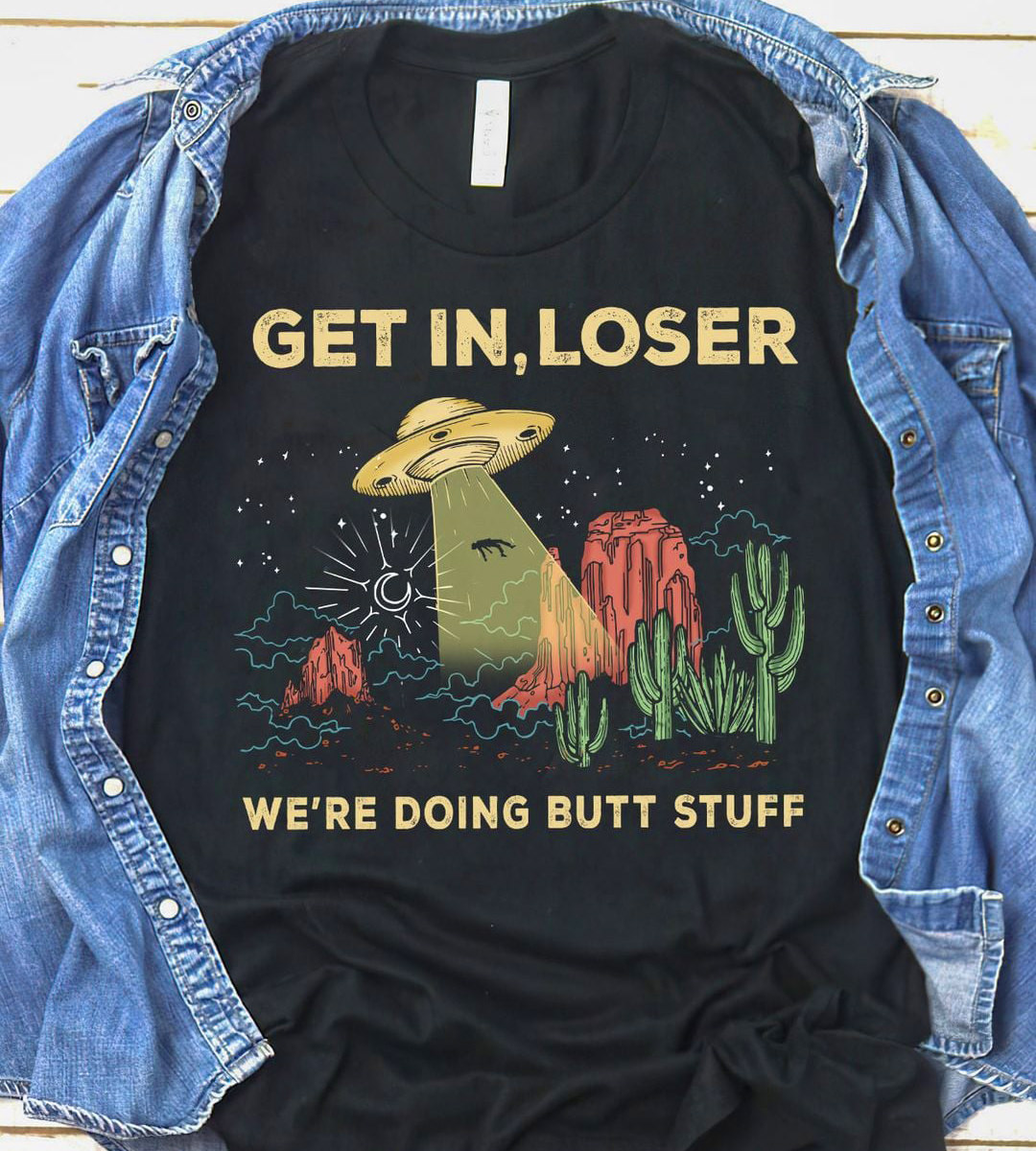 A T-shirt showing a human being beamed aboard a flying saucer saying GET IN, LOSER — WE'RE DOING BUTT STUFF!