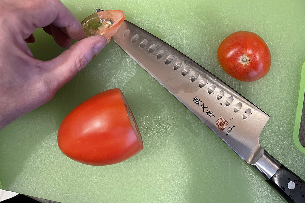 A very thinly-sliced tomato next to my MAC Chef's Knife