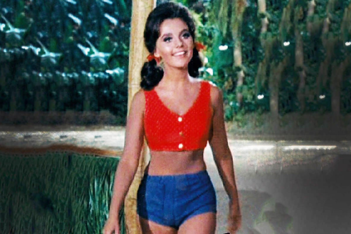 Dawn Wells as Mary Ann on Giligan's Island wearing shorts and a halter top and looking gorgeous.