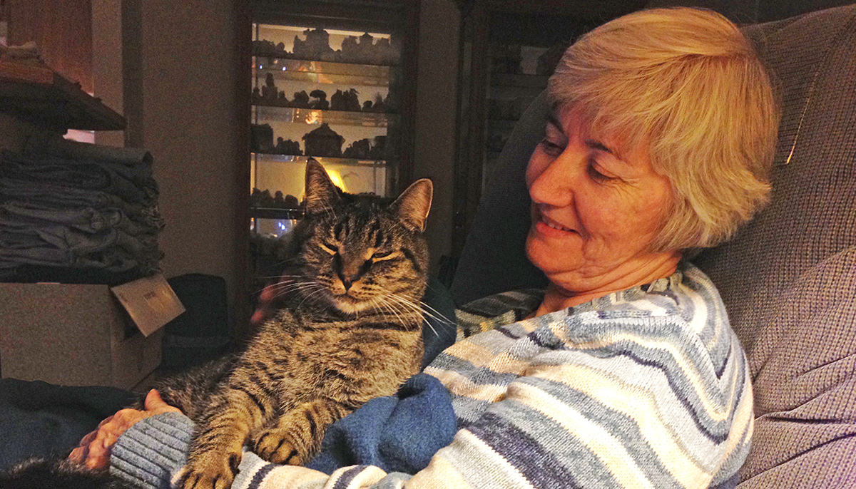 Mom miling while sitting with Spanky on her lap.