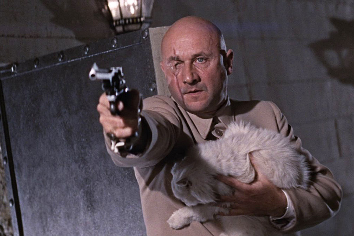 Donald Pleasence as Blofeld... pointing a gun and holding a longhair white cat.