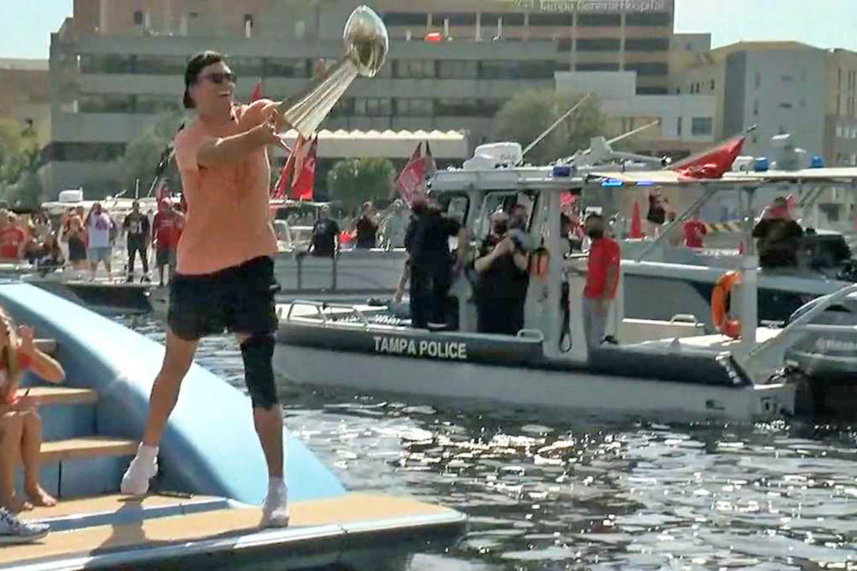 Tom Brady tossing the trophy to fans in Tampa.