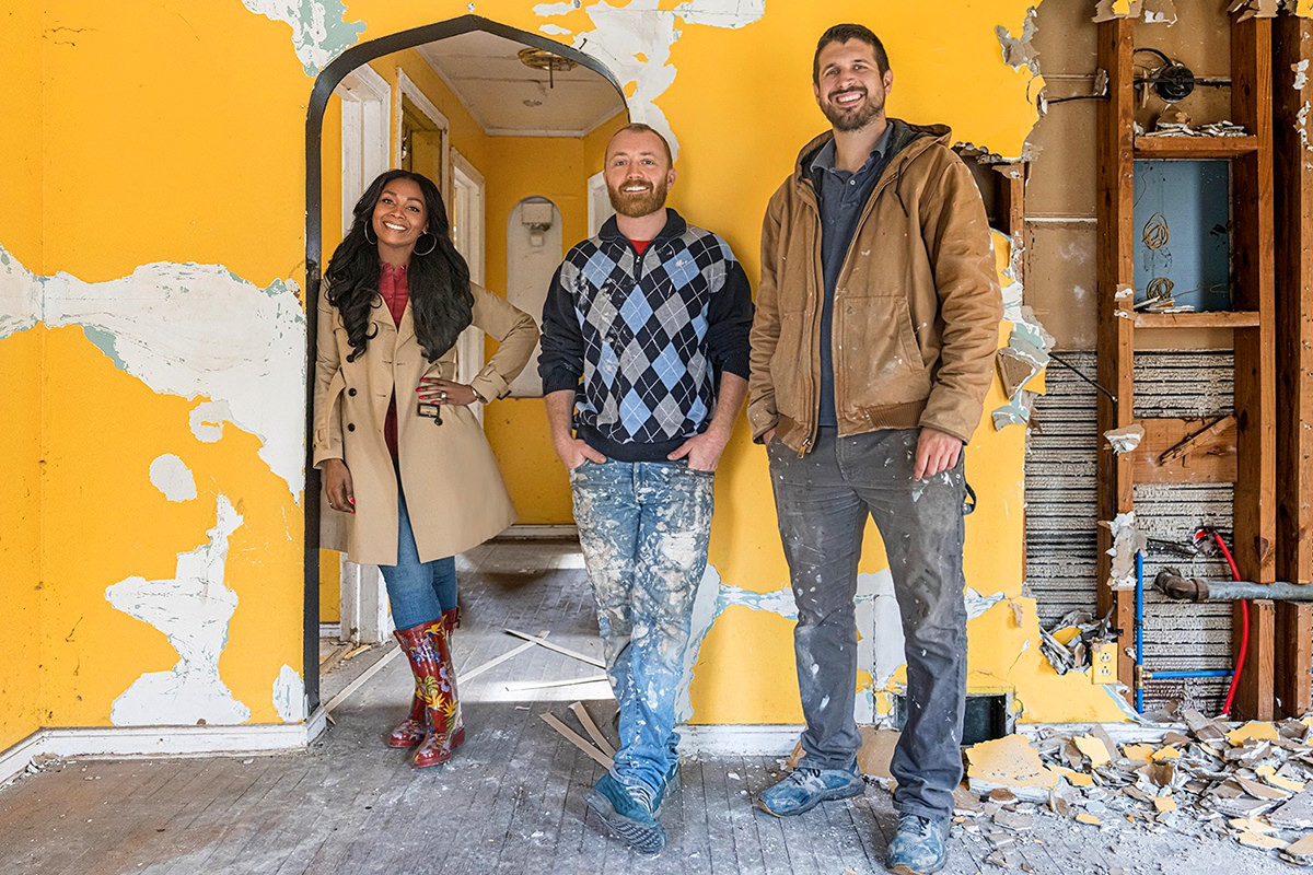 The team from Bargain Block standing in a house that's been ripped out.