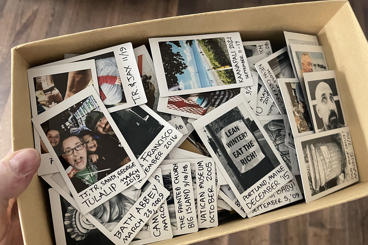 A box filled with hundreds of Instax photos.