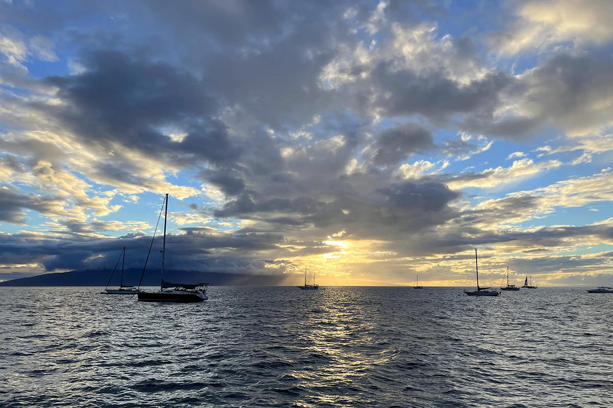 Boats off the coast of Lahaina as the sun sets.