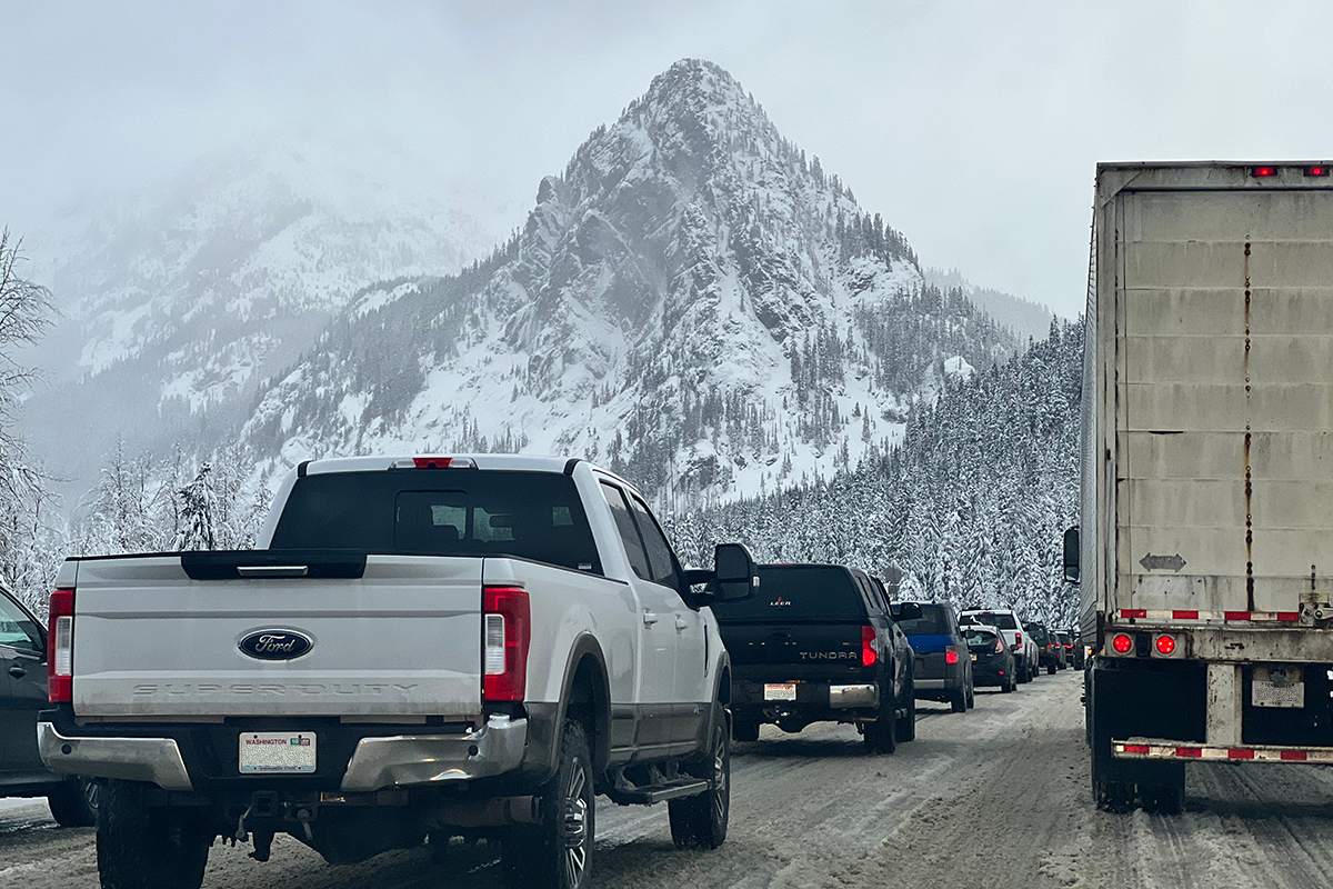 A flood of cars driving very, very slowly through the beautiful mountainscape