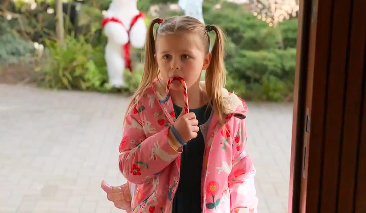 Phoebe with a candy cane at Keeley's door.