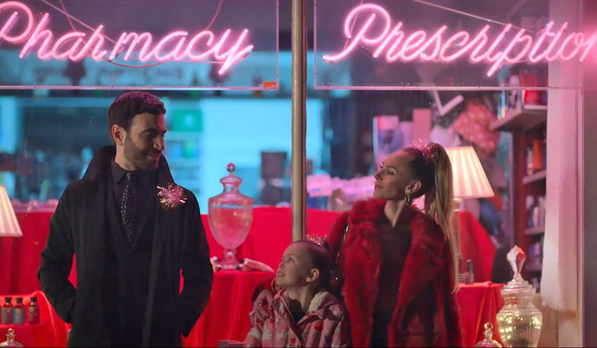 Roy, Keelye, and Phoebe bathed in a beautiful pink glow from a neon sign.