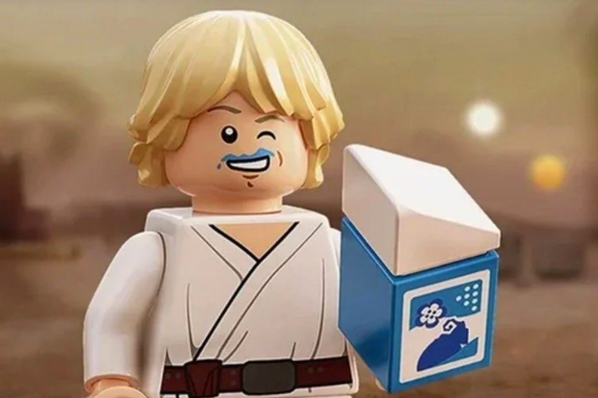 Luke minifig drinking blue milk from a carton.