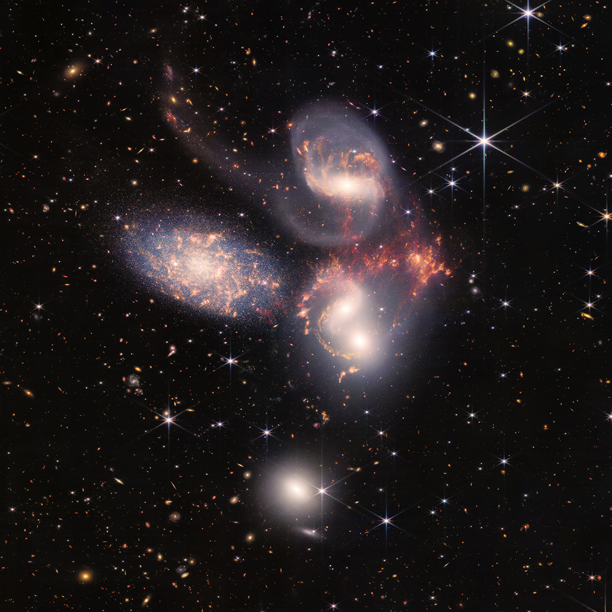A quintet of nebulas with thousands of galaxies around them.