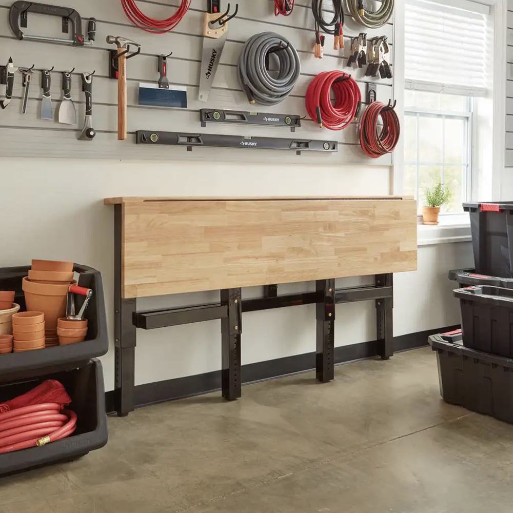 Home Depot bench, neatly folded against a garage wall.