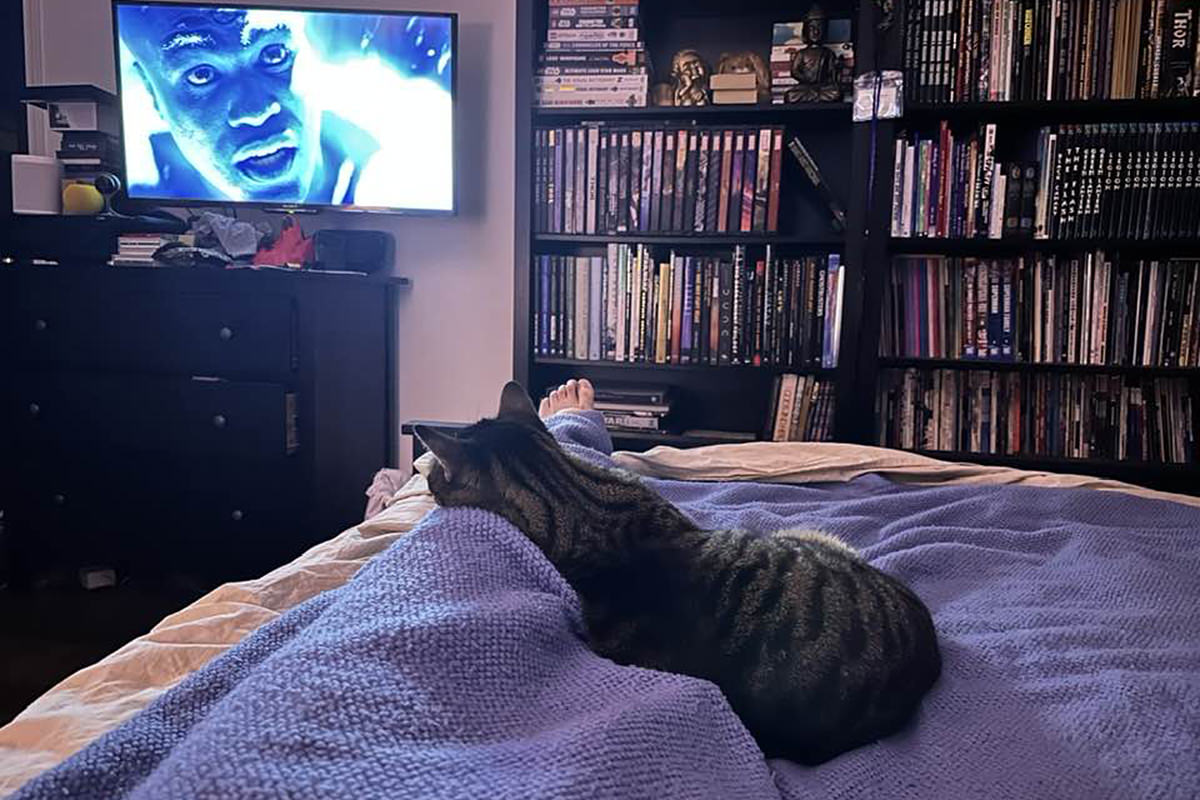 Jake watching Dr. Manhattan on TV.