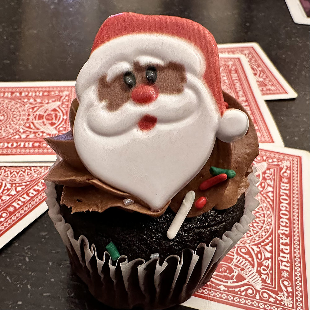 Cupcake with a Santa decoration on top.