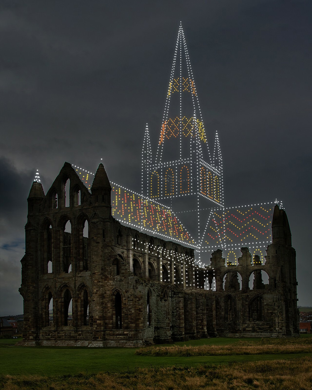 Whitby Abbey ruins completed by drone lights.