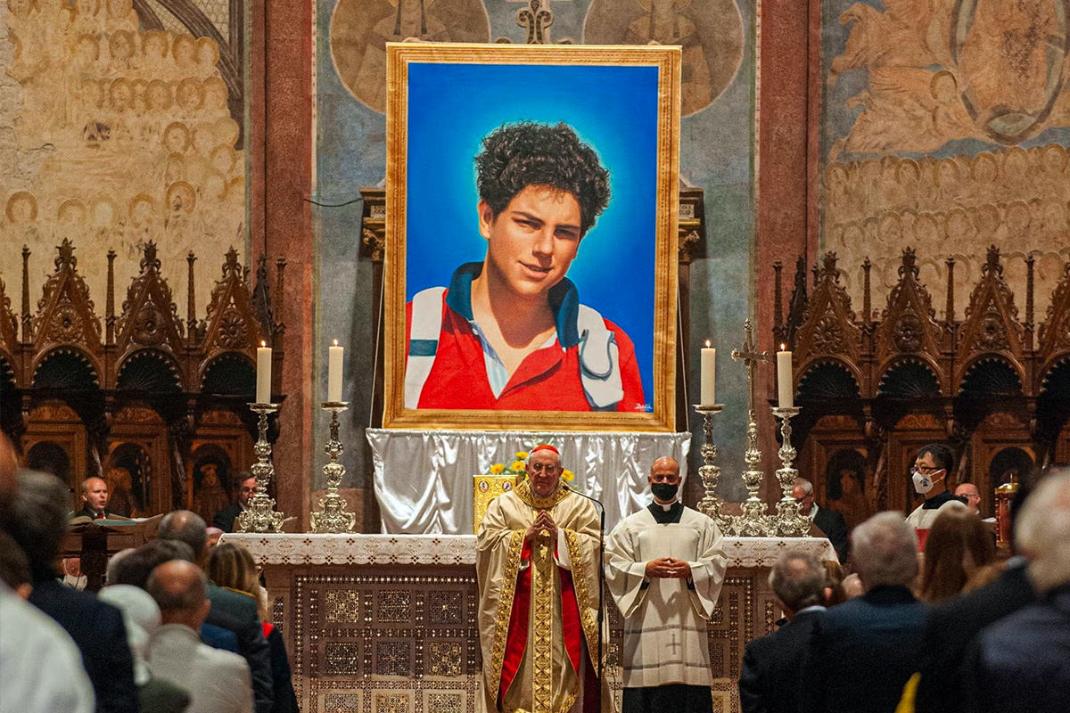 A portrait of Carlo Acutis on display on an altar of a Catholic Church at a church service.