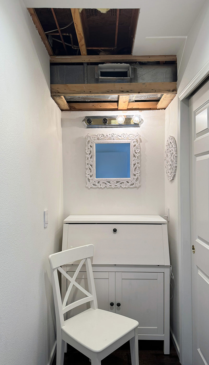 My guest room closet nook all cleaned up but with a massive hole in the ceiling.