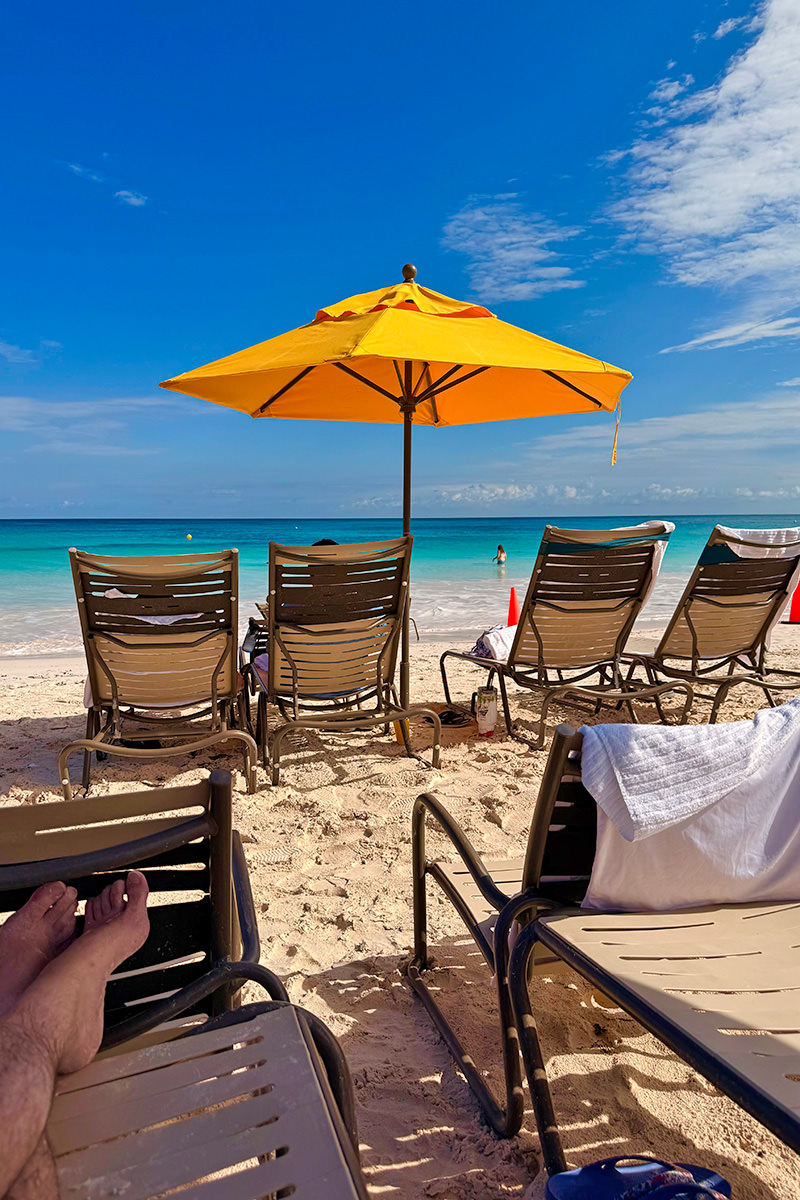 Laying under an umbrella at the beach