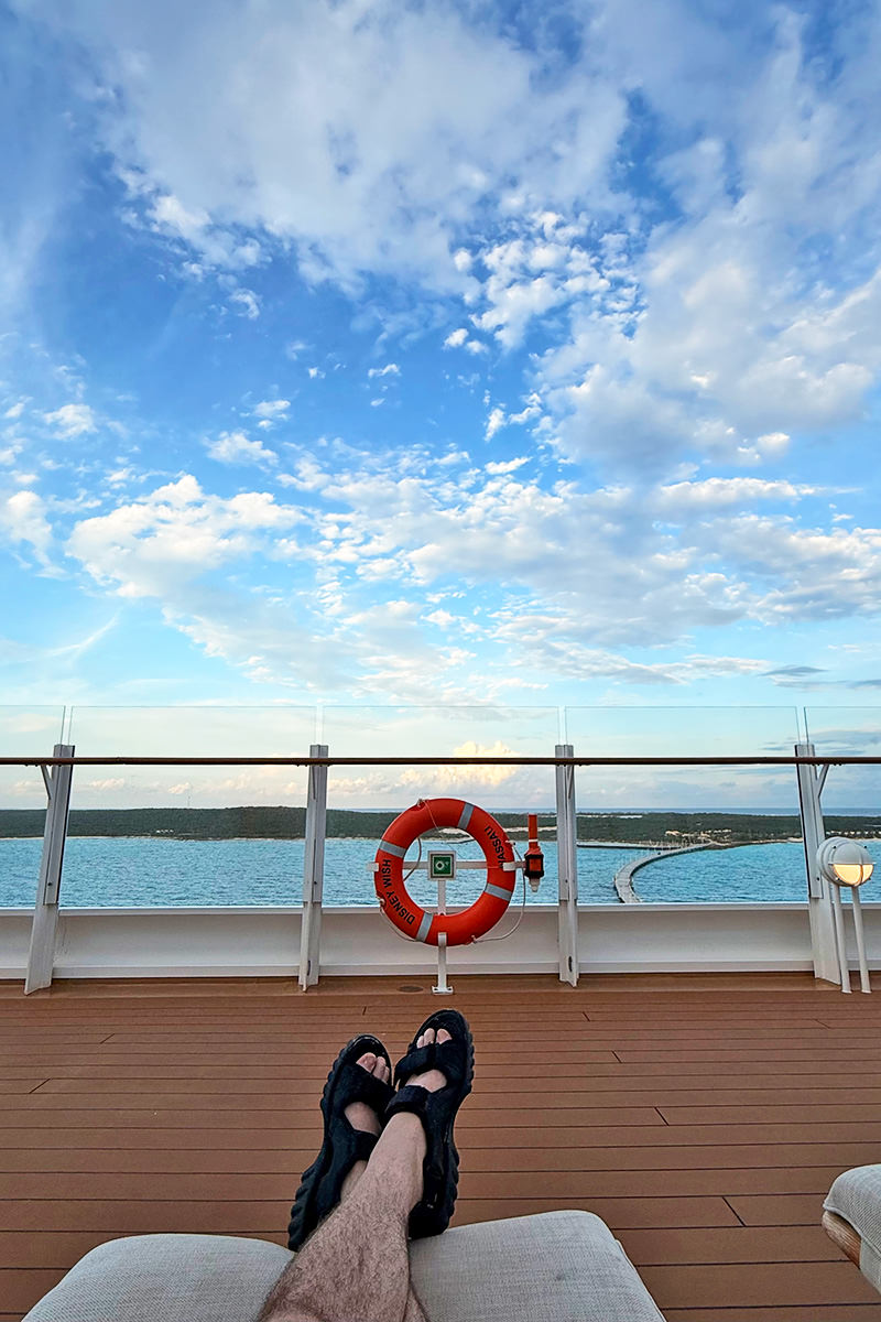 Laying under an umbrella at the beach