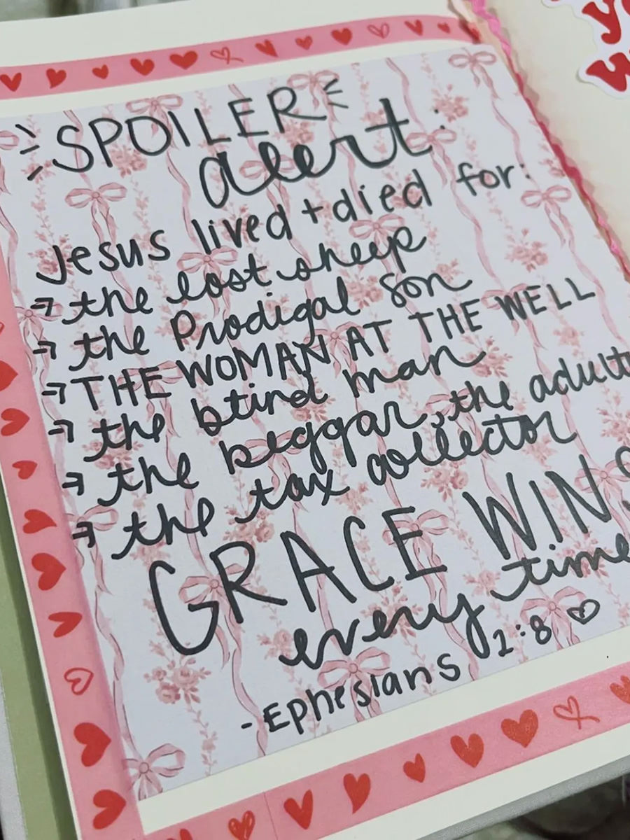 A Bible page with decorations and writing all over it.