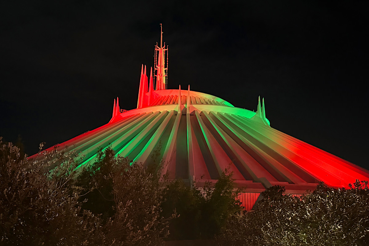 Space Mountain with red and green lights shining on it