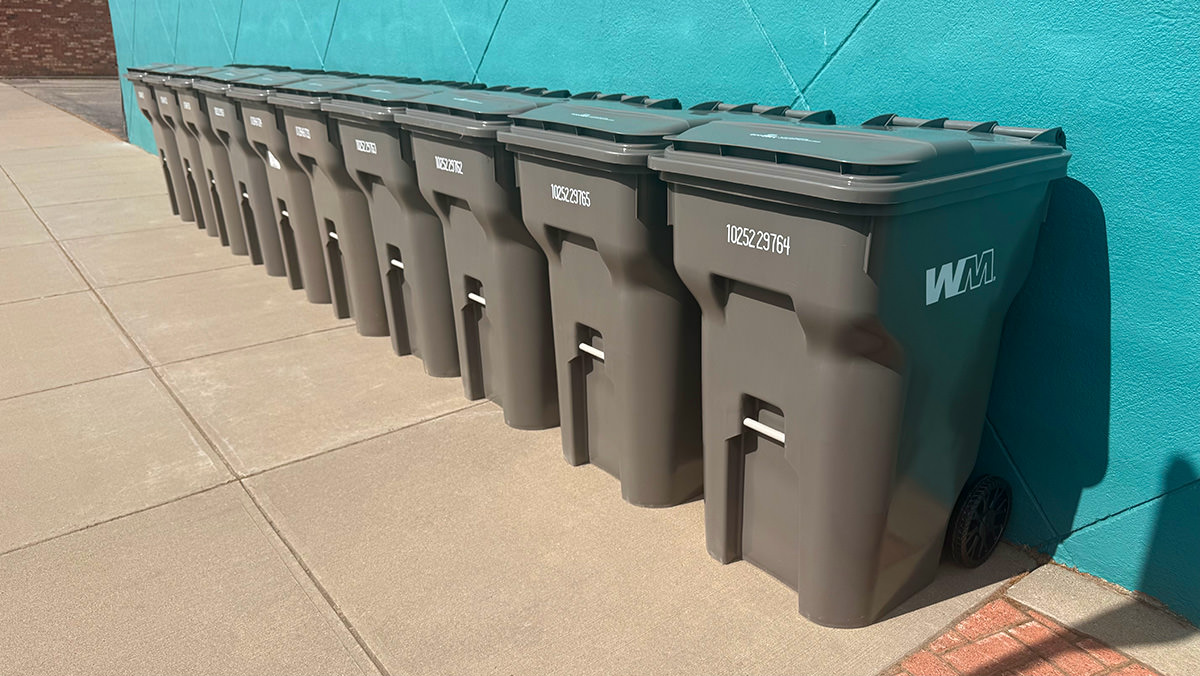 Row of trashcans in the sun.
